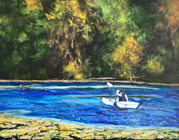 A man in a white kayak paddles on Holland Lake at Lebanon Hills Regional Park